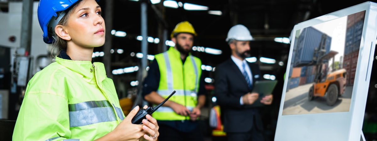 Mechanical engineer woman holding radio working industry wearing safety reflective vest